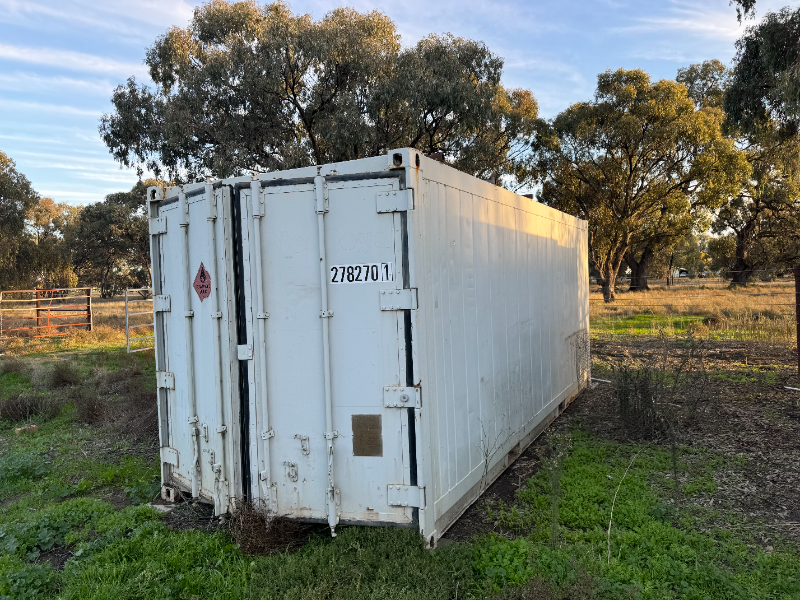 Lot 123 - 20' Shipping container with rails | AuctionsPlus